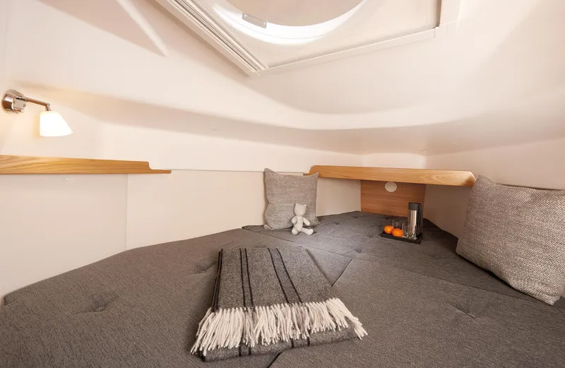 Slide: The Image of Cozy interior cabin of 2026 Dragonfly 28 sailboat with cushions and soft lighting. - 11