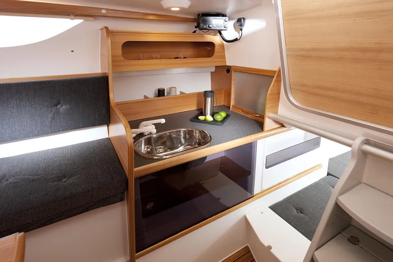 Slide: The Image of Compact and modern interior of 2026 Dragonfly 28 sailboat with kitchenette and seating. - 13
