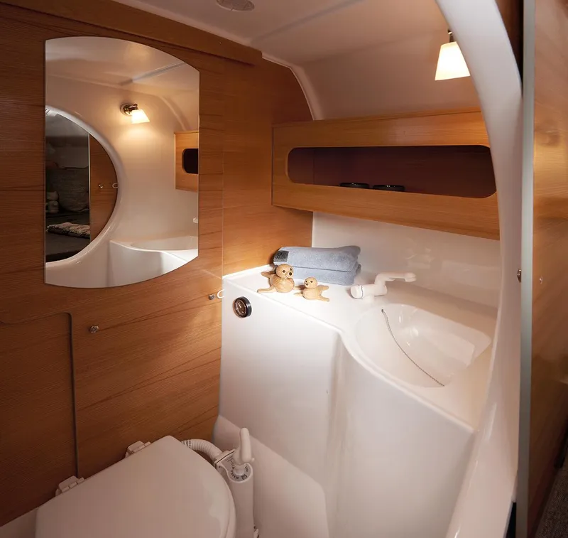 Slide: The Image of Compact bathroom in 2026 Dragonfly 28 sailboat with wooden accents and modern fixtures. - 14