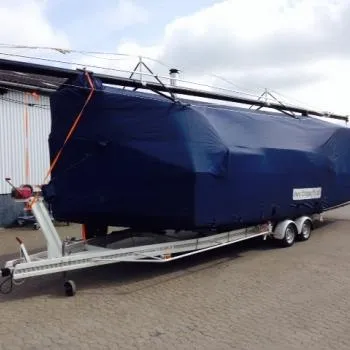 Slide: The Image of Covered Dragonfly 28 sailboat on trailer, 2026 model, parked outdoors. - 16