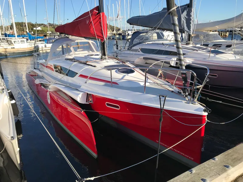 Slide: The Image of Red Dragonfly 28 trimaran sailboat docked in marina, 2026 model. - 4