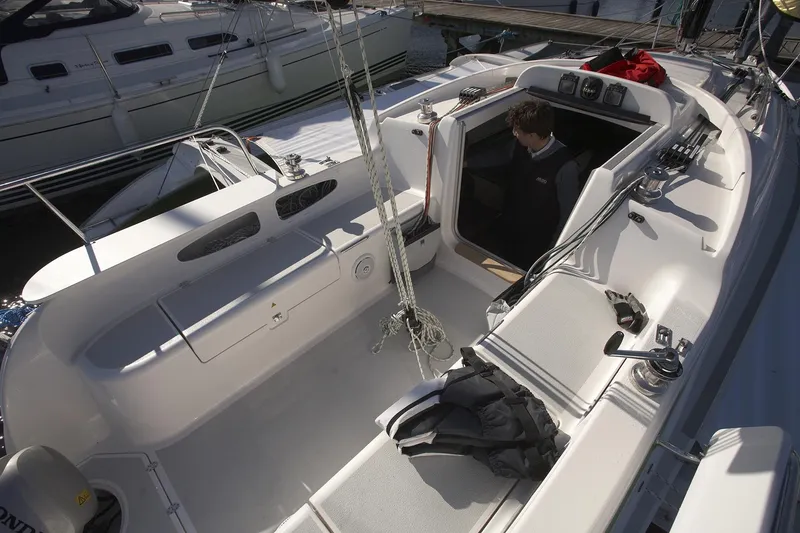 Slide: The Image of Modern Dragonfly 28 sailboat cockpit, 2026 model, with open cabin entrance and seating area. - 7