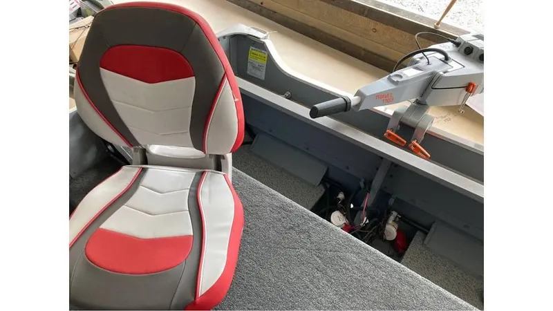 Slide: The Image of 2024 Smoker Craft Big Fisherman 16 boat interior with red and gray seating. - 2