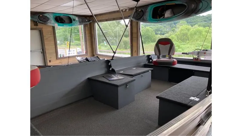 Slide: The Image of 2024 Smoker Craft Big Fisherman 16 interior with seating and storage compartments. - 4