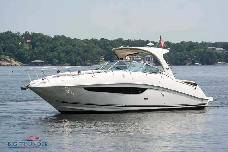 The Image of 2016 Sea Ray 370 Sundancer yacht on a serene lake. - 0