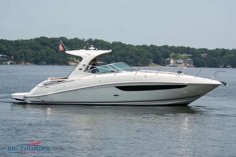 Slide: The Image of 2016 Sea Ray 370 Sundancer yacht on a serene lake. - 2
