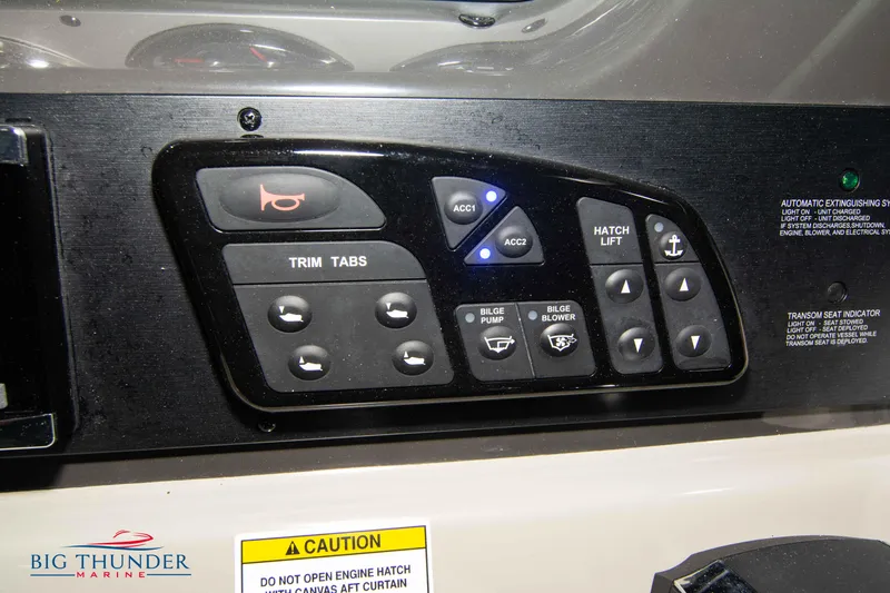 Slide: The Image of Control panel of a 2016 Sea Ray 370 Sundancer boat with various switches and buttons. - 28