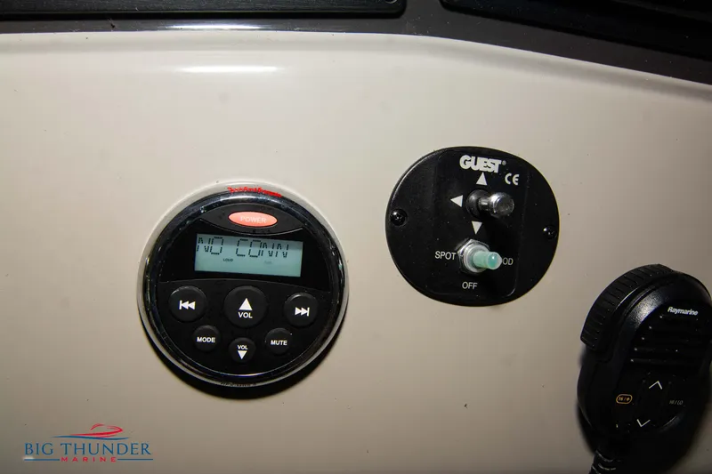 Slide: The Image of Control panel of 2016 Sea Ray 370 Sundancer boat with audio and spotlight controls. - 30