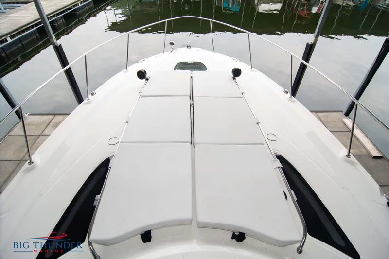 Slide: The Image of 2016 Sea Ray 370 Sundancer boat deck with sun pads, docked in marina. - 41