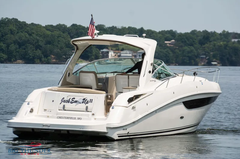 Slide: The Image of 2016 Sea Ray 370 Sundancer yacht on a serene lake. - 5