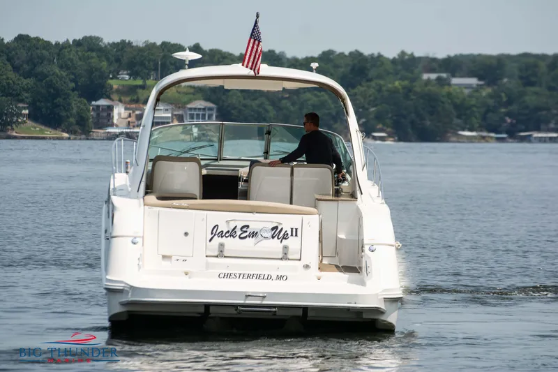 Slide: The Image of 2016 Sea Ray 370 Sundancer cruising on a lake with American flag. - 6