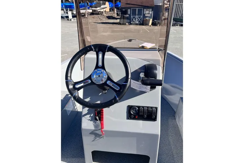 Slide: The Image of 2024 Smoker Craft 160 Freedom CC boat console with steering wheel and controls. - 5