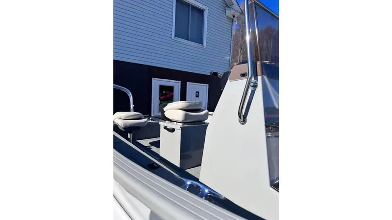 Slide: The Image of 2024 Smoker Craft 160 Freedom CC boat interior with seating and console. - 6