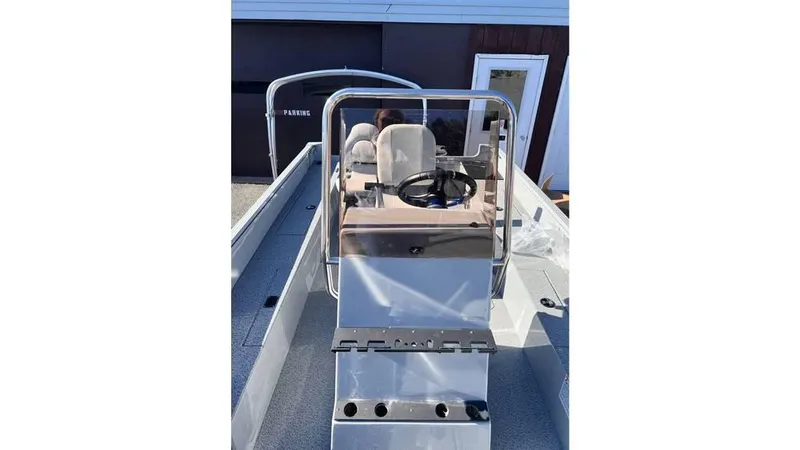 Slide: The Image of 2024 Smoker Craft 160 Freedom CC boat, center console view with steering wheel and seating. - 7