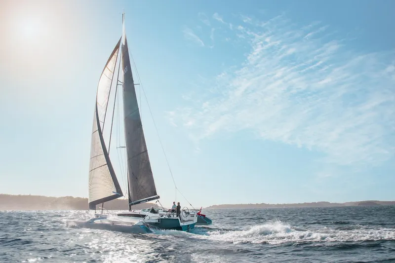 Slide: The Image of Sailing yacht Dragonfly 40 gliding on open sea under clear blue sky, 2026 model. - 3