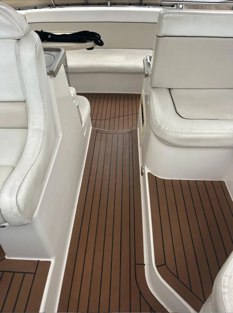 Slide: The Image of 2006 Rinker 390 Express Cruiser interior with white seating and wooden flooring. - 10