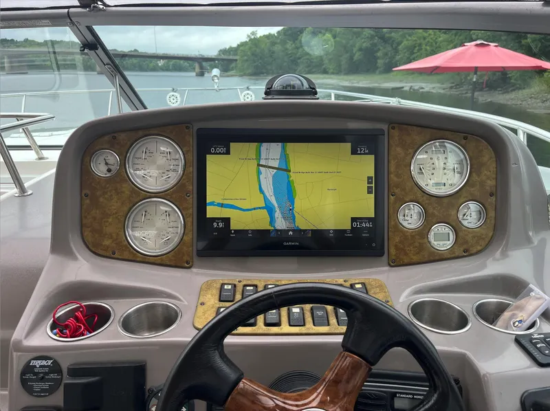 Slide: The Image of Dashboard of a 2006 Rinker 390 Express Cruiser with navigation display. - 11