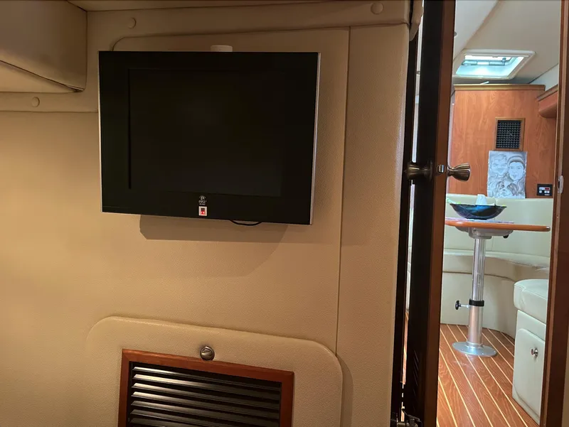 Slide: The Image of Flat-screen TV in the cabin of a 2006 Rinker 390 Express Cruiser yacht. - 16