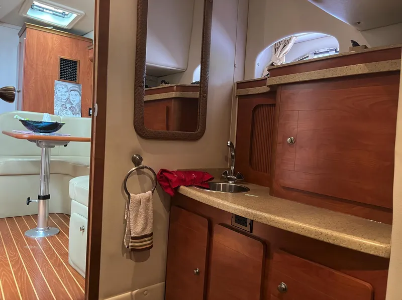 Slide: The Image of 2006 Rinker 390 Express Cruiser interior with kitchenette and seating area. - 17