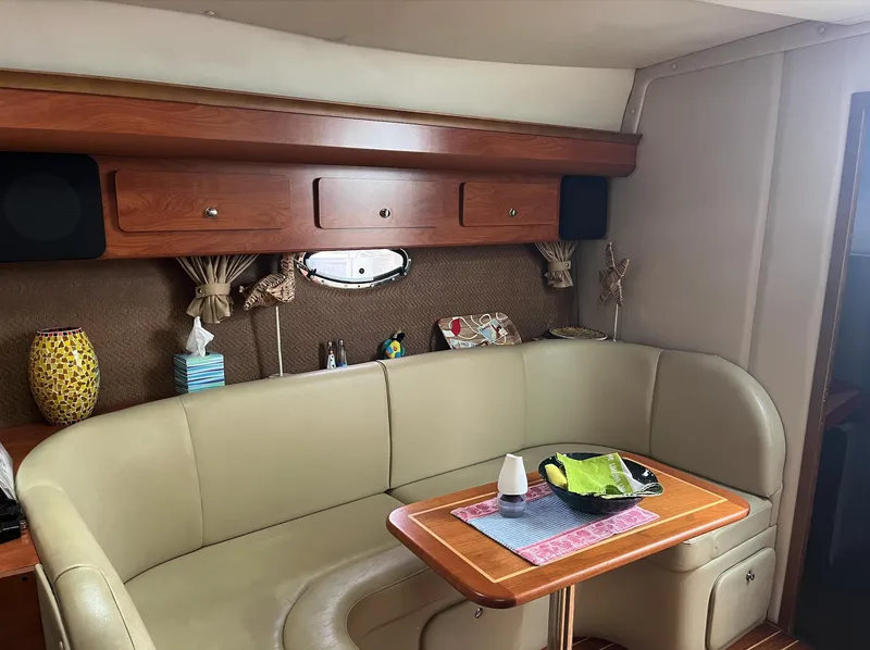 Slide: The Image of Interior of 2006 Rinker 390 Express Cruiser with beige seating and wooden table. - 19