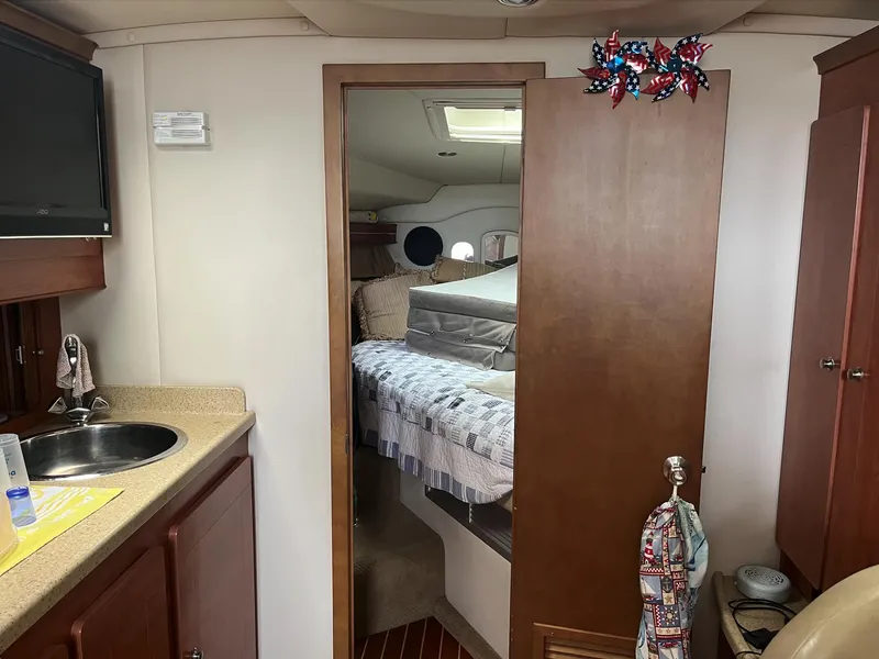 Slide: The Image of Interior of 2006 Rinker 390 Express Cruiser with kitchenette and cozy sleeping area. - 20