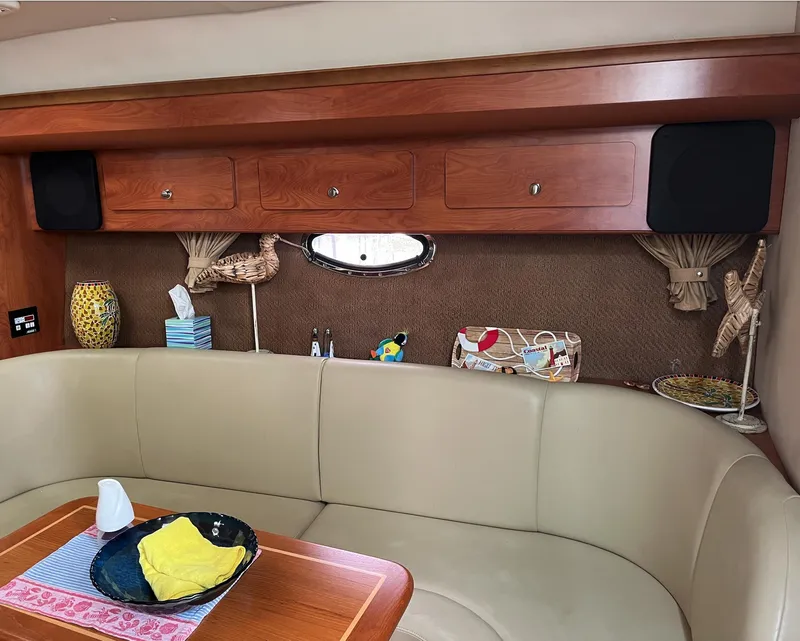 Slide: The Image of Interior of 2006 Rinker 390 Express Cruiser with beige seating and wooden cabinetry. - 21