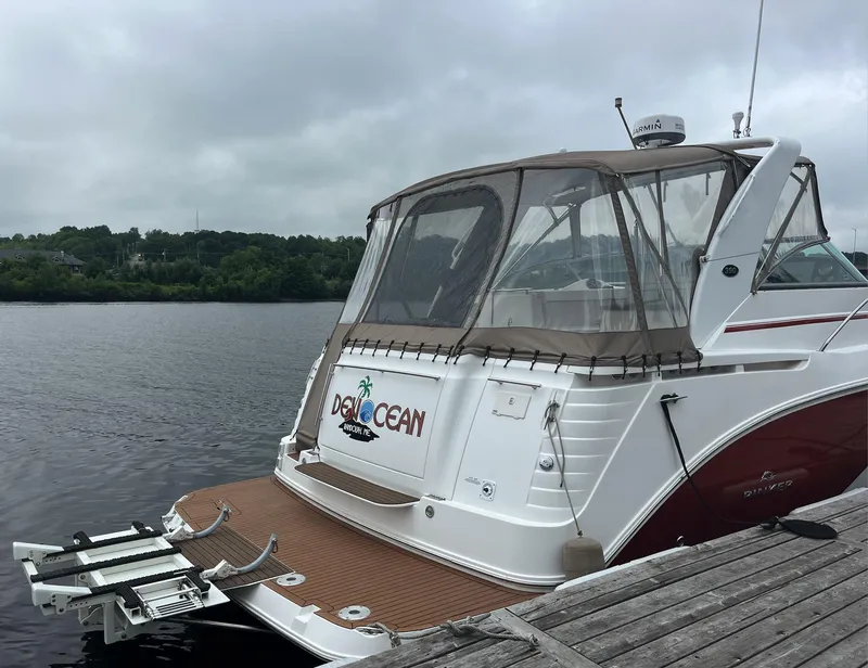 Slide: The Image of 2006 Rinker 390 Express Cruiser docked by a wooden pier on a cloudy day. - 4