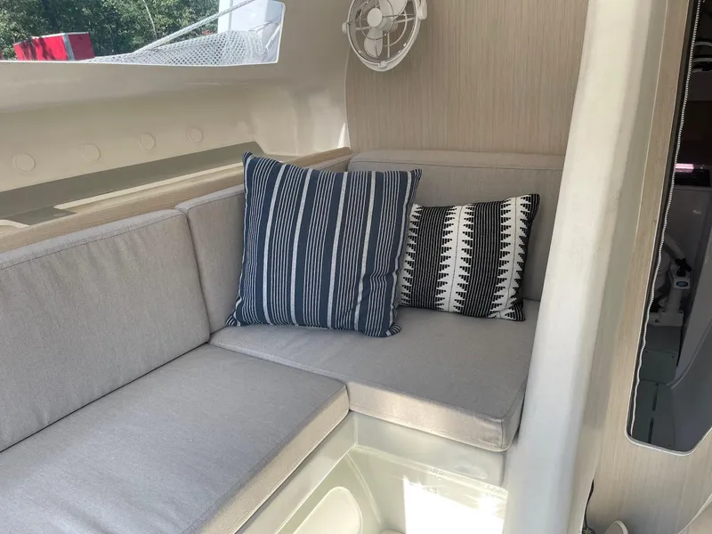 Slide: The Image of Cozy seating area on 2025 Corsair 880 boat with striped and patterned cushions. - 13