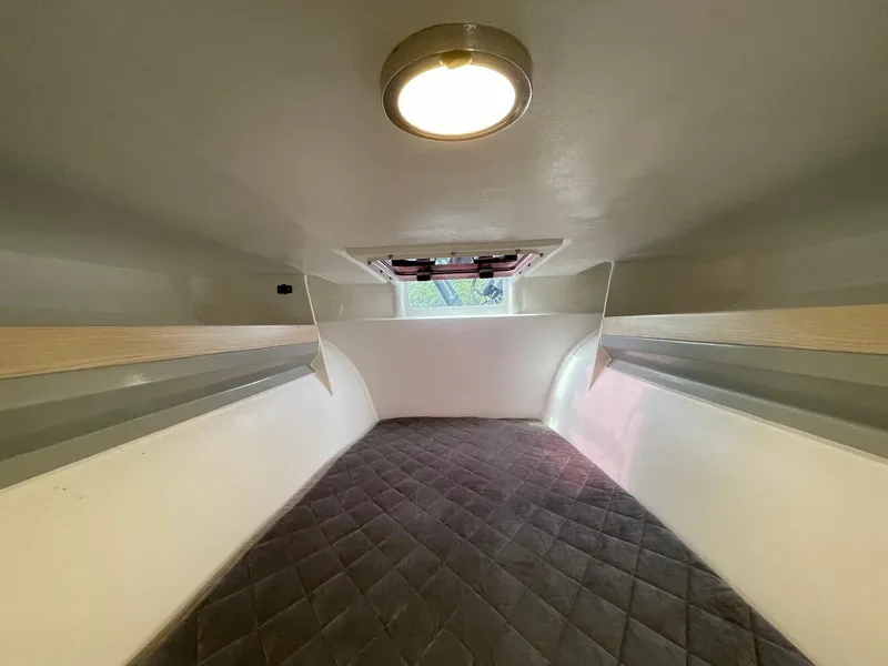 Slide: The Image of Interior cabin of 2025 Corsair 880, featuring a cozy sleeping area with overhead light. - 14