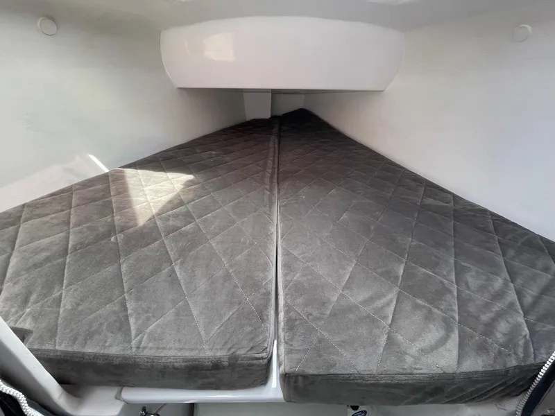 Slide: The Image of Interior cabin of 2025 Corsair 880 sailboat with gray cushioned bedding. - 15