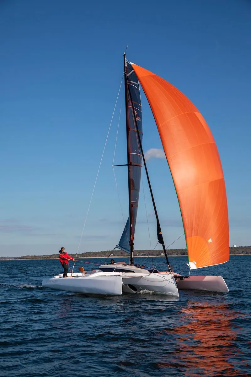 Slide: The Image of Sailing catamaran Corsair 880, 2025 model, with orange sail on open water. - 5