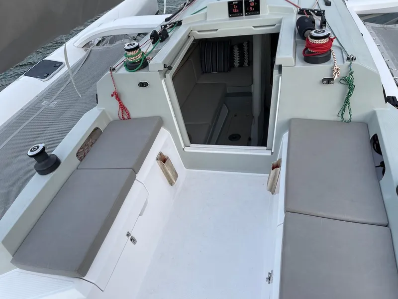 Slide: The Image of 2025 Corsair 880 sailboat cockpit with seating and cabin entrance. - 7