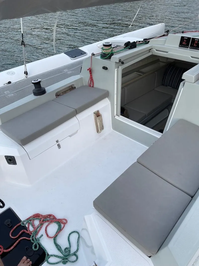 Slide: The Image of 2025 Corsair 880 sailboat cockpit with seating, ropes, and cabin entrance. - 8