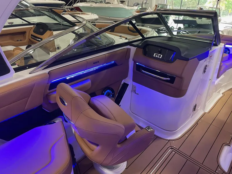 Slide: The Image of Interior of 2025 Chaparral 267 SSX boat with luxurious seating and modern dashboard. - 12
