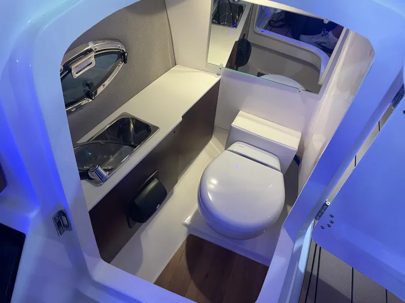 Slide: The Image of 2025 Chaparral 267 SSX boat interior bathroom with toilet and sink. - 14