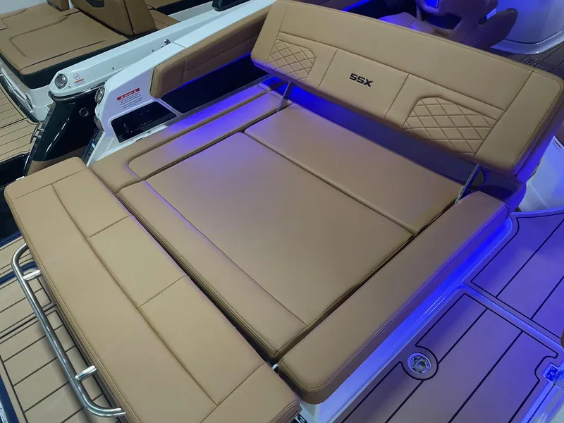 Slide: The Image of 2025 Chaparral 267 SSX boat with tan leather seating and blue LED lighting. - 16