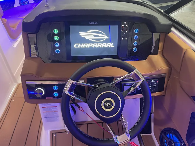 Slide: The Image of 2025 Chaparral 267 SSX boat dashboard with steering wheel and digital display. - 17