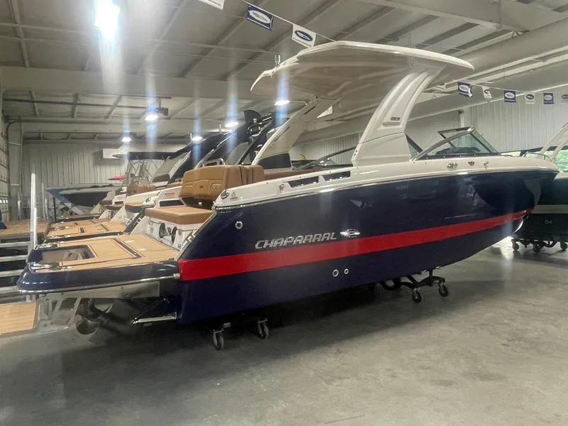 Slide: The Image of 2025 Chaparral 267 SSX boat in showroom, rear view. - 3