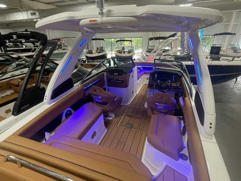 Slide: The Image of 2025 Chaparral 267 SSX boat interior with modern seating and blue LED lighting. - 6