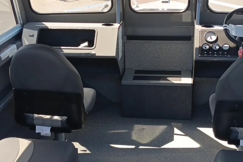 Slide: The Image of Interior of 2025 Spartan 200 Astoria boat with dual seats and control panel. - 2