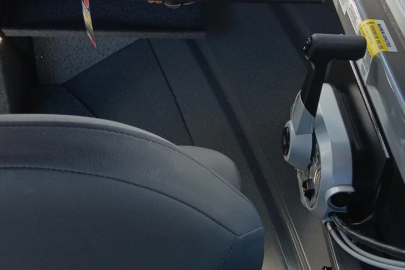 Slide: The Image of Interior of 2025 Spartan 200 Astoria boat with control lever and seat. - 4