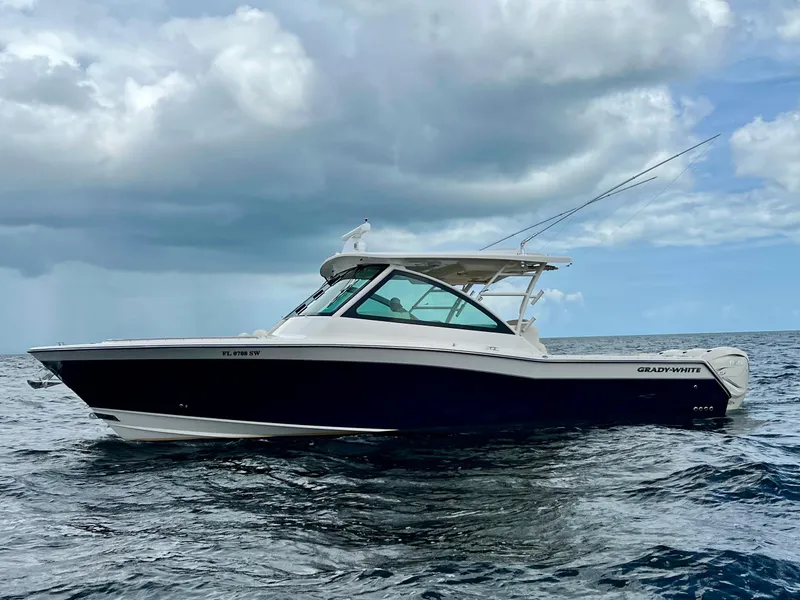 Slide: The Image of 2021 Grady-White Freedom 375 boat on open water under cloudy sky. - 0