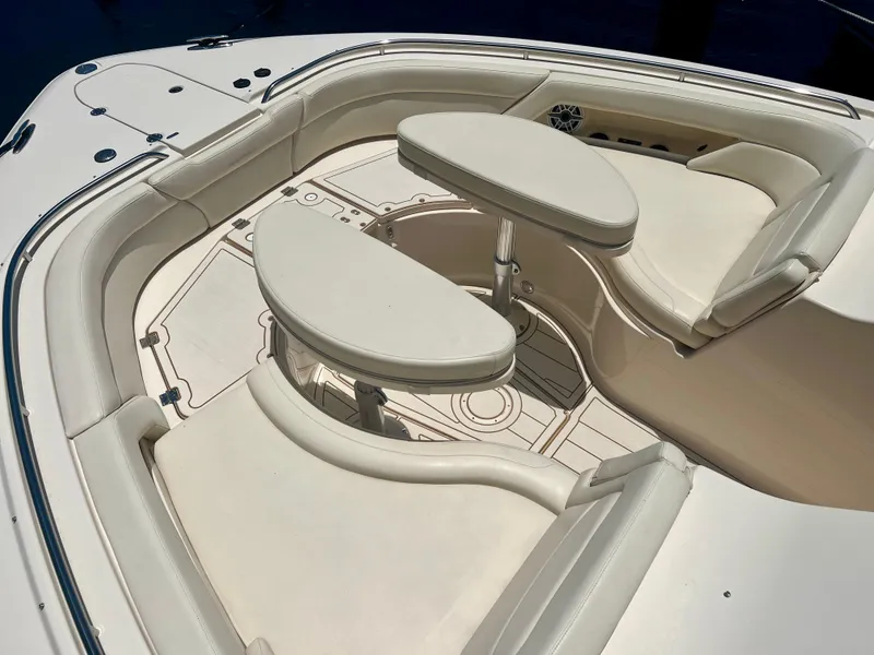 Slide: The Image of 2021 Grady-White Freedom 375 boat interior with cushioned seating and tables. - 1