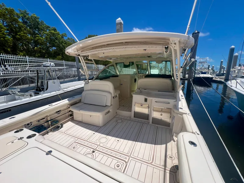 Slide: The Image of 2021 Grady-White Freedom 375 boat with spacious deck and seating at marina. - 10