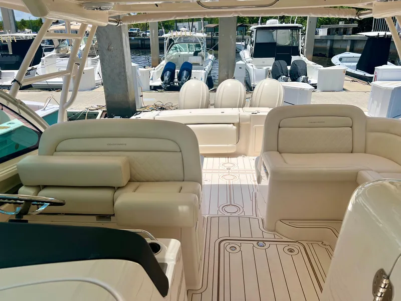 Slide: The Image of 2021 Grady-White Freedom 375 boat interior with luxurious seating at marina. - 11