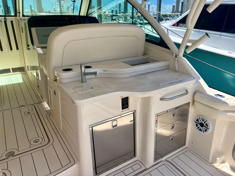 Slide: The Image of 2021 Grady-White Freedom 375 boat interior with kitchenette and seating area. - 15