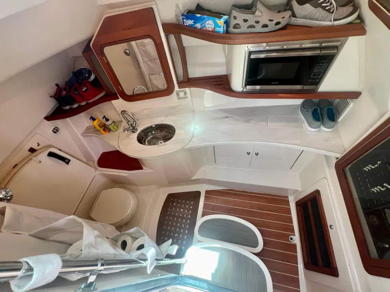 Slide: The Image of 2021 Grady-White Freedom 375 boat interior with kitchenette, sink, and toilet. - 26