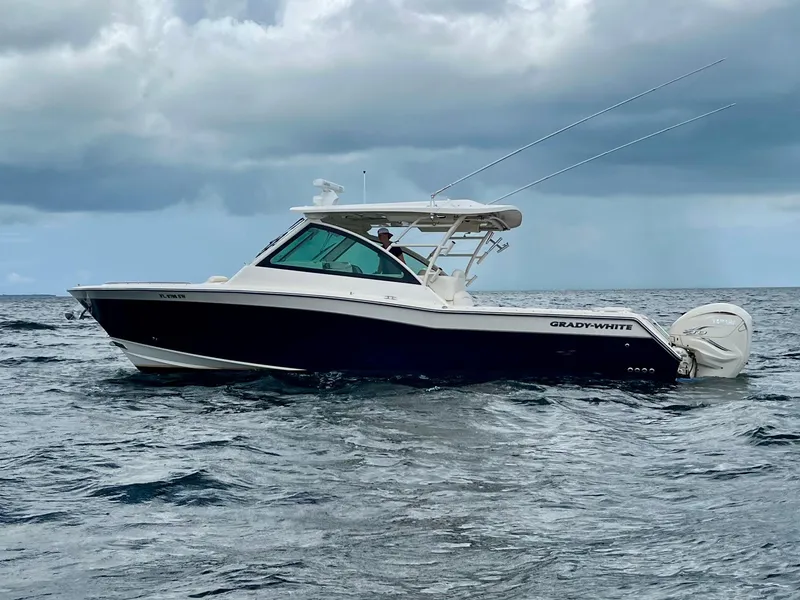 Slide: The Image of 2021 Grady-White Freedom 375 boat on open water under cloudy skies. - 3