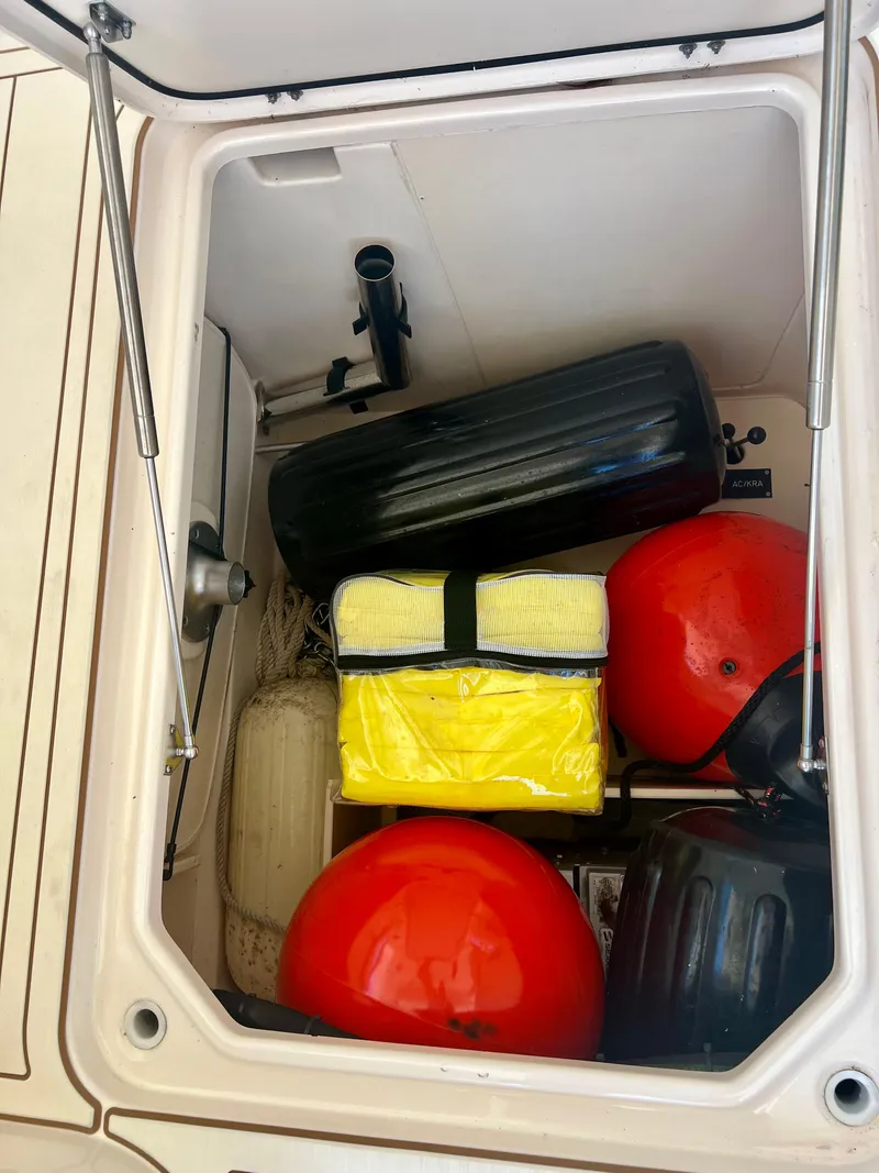 Slide: The Image of Storage compartment of a 2021 Grady-White Freedom 375 boat with various boating equipment. - 33