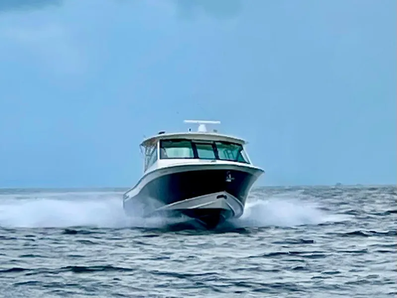 Slide: The Image of 2021 Grady-White Freedom 375 boat cruising on open water. - 37